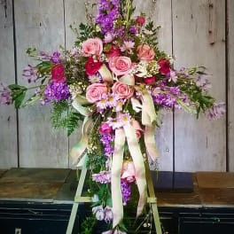Tall floral spray with pink and purple flowers on a stand