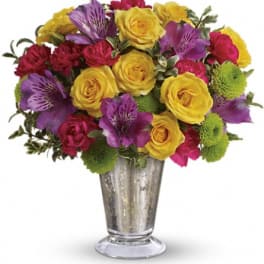 Colorful bouquet of roses and alstroemeria in a silver vase