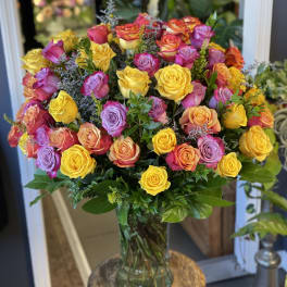 Bouquet of multicolored roses in a clear glass vase