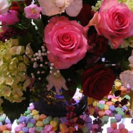 Pink and red roses with pale hydrangeas in a vase
