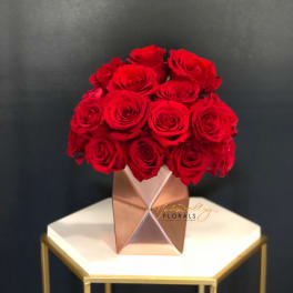 Red rose bouquet in a geometric metallic vase