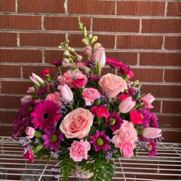 Pink and purple mixed flower arrangement with roses and tulips
