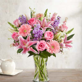 Pink and purple mixed bouquet in a clear glass vase