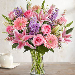 Pink and purple mixed bouquet in a clear glass vase