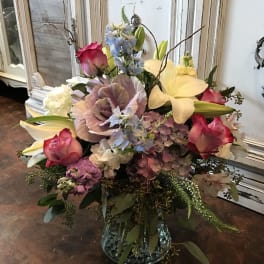 Mixed bouquet with pink roses, lilies, and hydrangeas in a glass vase