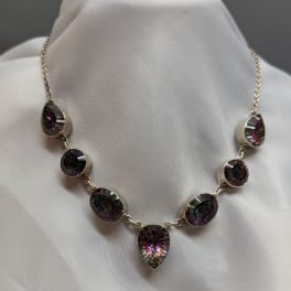 Faceted gemstone necklace on white fabric