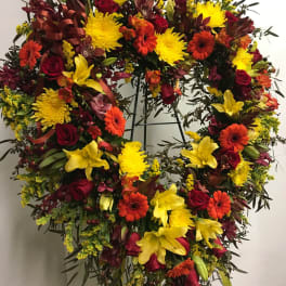 Heart-shaped floral wreath with red, yellow, and orange blooms