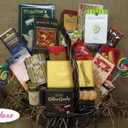 Basket of assorted snack and candy gift boxes with lollipops