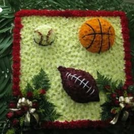 Floral sports-themed arrangement with basketball and football designs