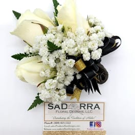 White rose corsage with baby's breath and black ribbon