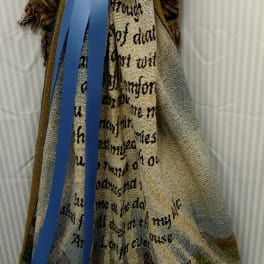 Decorative woven blanket with a large blue ribbon bow