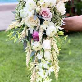 Trailing bouquet of pink and white roses with cascading white orchids