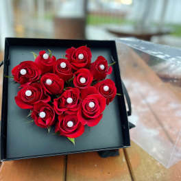 Heart-shaped box of red roses with pearl accents