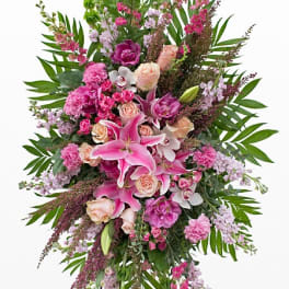 Tall pink and lavender floral spray with lilies and roses