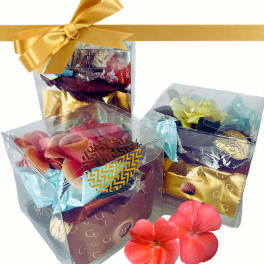 Gift boxes of chocolates with decorative flowers and ribbon