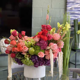 Large arrangement of pink and red roses in a white vase