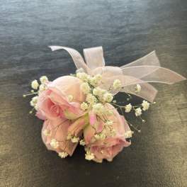 Small pink rose bouquet with baby's breath and a sheer ribbon