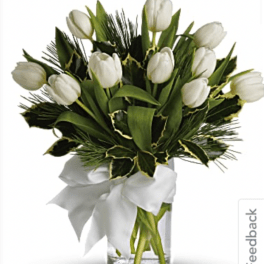 White tulip bouquet in a clear glass vase with a white ribbon