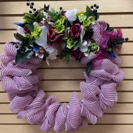 Pink mesh wreath with roses and green accents