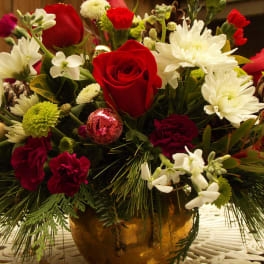 Red roses and white chrysanthemums in a gold vase