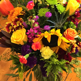 Mixed bouquet of bright flowers in a glass vase