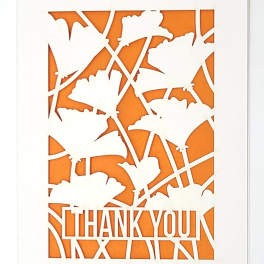 White thank-you card with orange floral cutout design