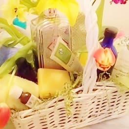 Gift basket with tulips, bath products, and soaps in a white wicker basket