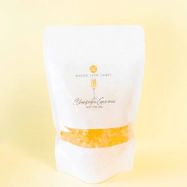 White candy bag labeled Champagne Gummies on a pale yellow background