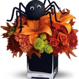 Halloween flower arrangement with a black spider decoration in a vase