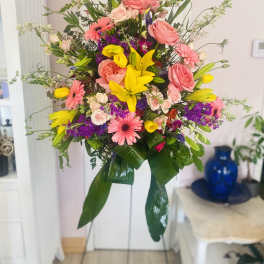 Tall mixed bouquet with pink roses, yellow lilies, and purple flowers