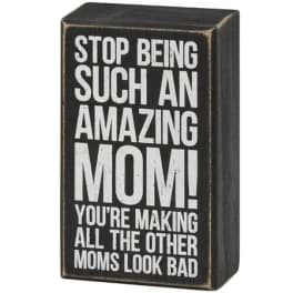 Black wooden block sign with white text about an amazing mom