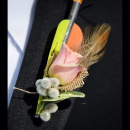 Pink rose boutonniere with dried grasses and a pencil
