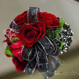 Small bouquet of red roses with black ribbon and silver accents