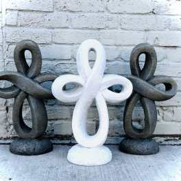 Three decorative looped sculptures in black and white