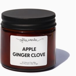 Amber glass jar candle with black lid and Apple Ginger Clove label