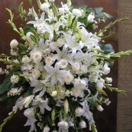 Large white floral spray with lilies and roses