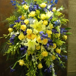 Large bouquet of yellow roses, lilies, and blue flowers