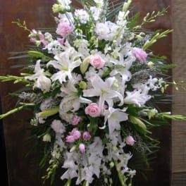 Large white and pink floral standing spray with lilies and roses