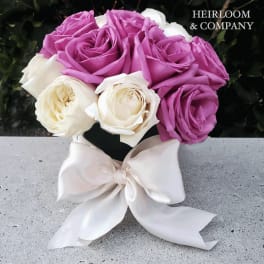 Bouquet of lavender and white roses tied with a white ribbon