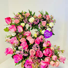 Heart-shaped rose arrangement with a Mother's Day pick