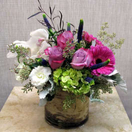 Pink and white flower arrangement in a glass vase