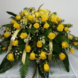 Large yellow rose arrangement with white filler flowers and ribbon accents