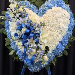 Heart-shaped blue and white floral standing spray with ribbon
