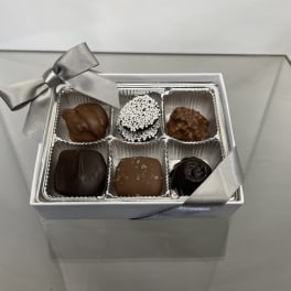 Box of assorted chocolates with a silver ribbon bow