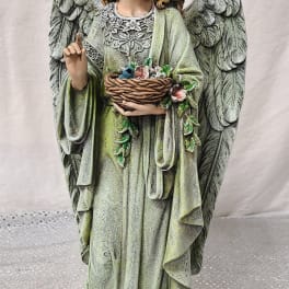 Angel statue holding a basket of flowers