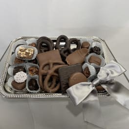 Tray of assorted chocolates tied with a silver ribbon