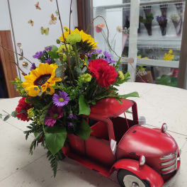Flowers arranged in a red vintage truck container