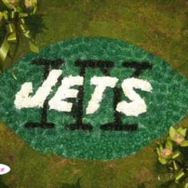 Green floral football with white "JETS" lettering