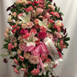Large pink and white standing floral spray with a ribbon