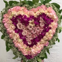 Heart-shaped floral spray with pink roses and purple orchids